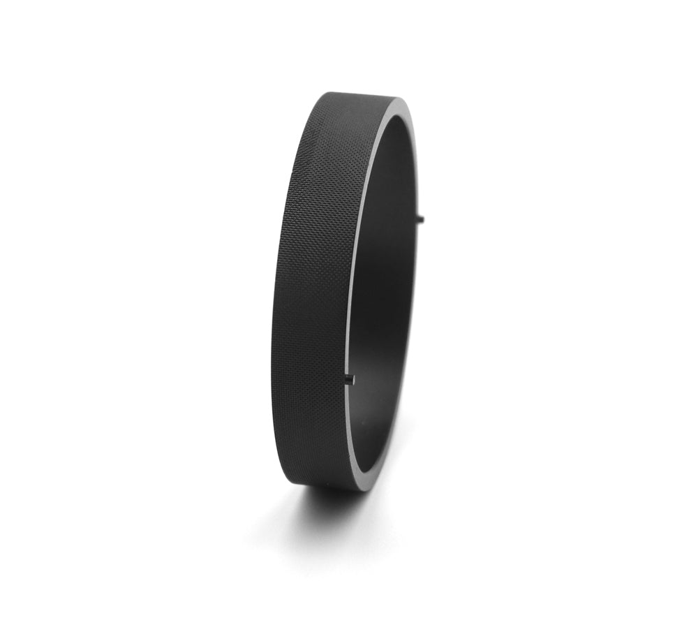 Side view of the Astroasis filter drawer ring showing textured grip surface and alignment pins
