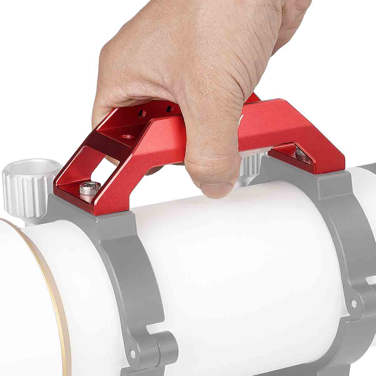 Hand using a red tool on a white cylindrical object with a gray base.